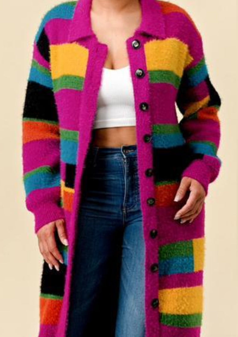 This pink multi colored long cardigan is a must have staple piece that I personally love truly enjoy . This cardigan is soft to the touch with large buttons and a collar. This cardigan is a  must have staple piece !